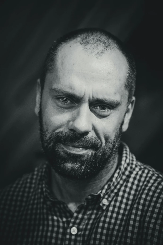 a black and white photo of a man with a beard